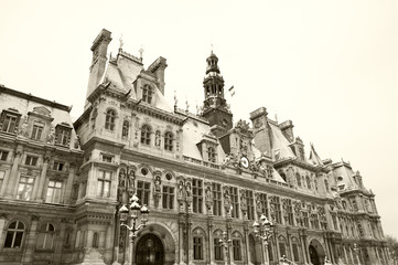 Paris, France. Hotel de ville (city hall) covered with snow in rare snowy morning in winter. Sepia photo.