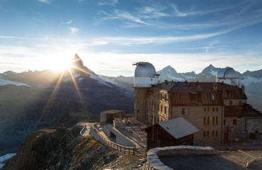 Planetarium at the Gornergrat and the sun setting behind the Matterhorn in Switzerland.