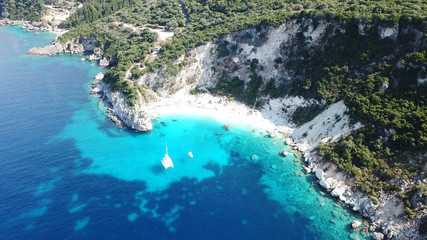 Obraz premium Aerial drone photo of iconic paradise sandy beach of Agiofili near port of Vasiliki with emerald crystal clear sea and sail boats docked, Lefkada island, Ionian, Greece