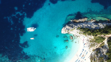 Aerial drone photo of tropical exotic caribbean paradise vegetated island with blue lagoon turquoise sea and sail boats