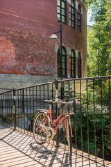 Fototapeta na wymiar bicycle parked on bridge near old building in oslo, norway