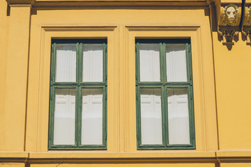 old yellow house with sculptures and windows in oslo, norway, full frame view