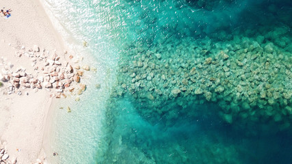 Aerial drone bird's eye view of famous and exotic sand tongue beach with clear emerald waters near castle of Santa Mavra in entrance of Lefkada island, Ionian, Greece