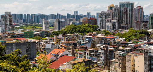 Great panoramic view of the urban landscape of Macau, one of the most densely populated territory worldwide. The idiosyncratic residential buildings tell a history of cohabitation between East & West.