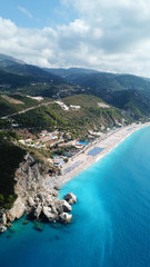 Obraz premium Aerial top view photo of sun beds in popular tropical paradise deep turquoise sandy beach of Kathisma, Lefkada island, Ionian, Greece