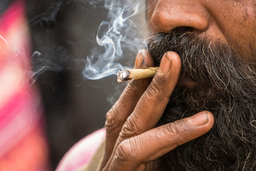 Hindu Sadhu smoking marijuana, locally called Ganja, form of cannabis sativa. tobacco user. smoker...