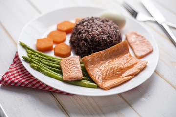 Health food concept, salmon with rice and vegetable on wood background