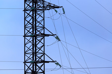 Metallic electric pillars against the blue sky