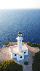 Fototapeta na wymiar Aerial drone bird's eye view photo of iconic lighthouse in Cape Lefkada the Southest part of the island, Ionian, Greece