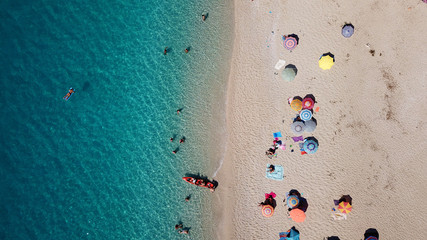 Aerial drone bird's eye view photo of popular beach of Milos with turquoise clear waters and sun beds, island of Lefkada, Ionian, Greece
