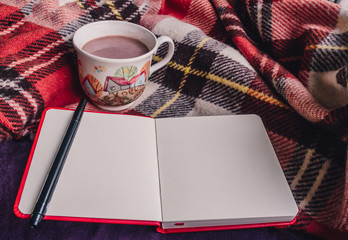 Red plaid, a Cup of hot cocoa, sketchbook and pen, winter comfort