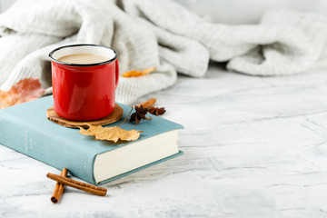 Autumn light still life with coffee and book
