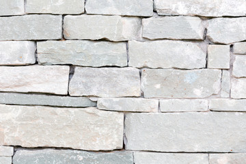 Part of the stone wall. Grey brick wall background texture.