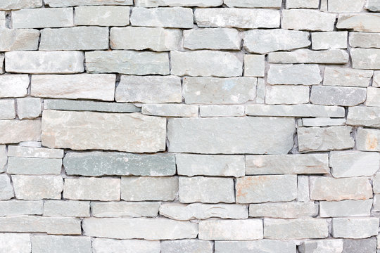 Part of the stone wall. Grey brick wall background texture.