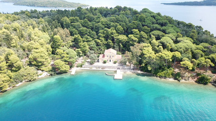 Aerial drone photo of iconic uninhabited island of Madouri in bay of Nydri and Mansion of 19th-century poet Aristotelis Valaoritis, Lefkada, Ionian, Greece