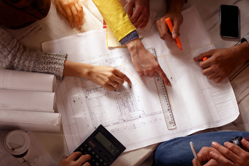 Architect team discussing on blueprints.