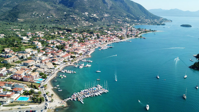 Aerial drone bird's eye view photo of iconic port of Nidri or Nydri a safe harbor for sail boats and famous for trips to Meganisi, Skorpios and other Ionian islands, Leflkada island, Ionian, Greece