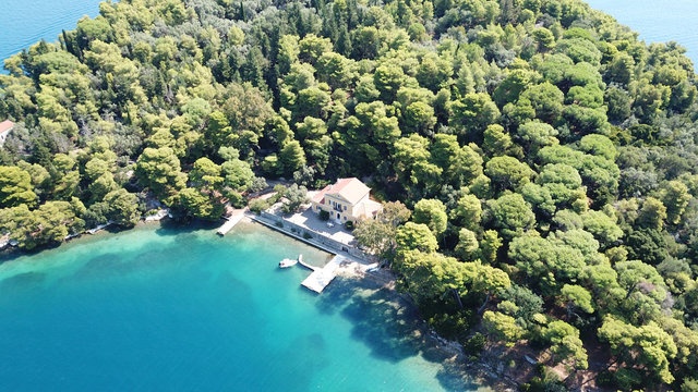 Aerial drone photo of iconic uninhabited island of Madouri in bay of Nydri and Mansion of 19th-century poet Aristotelis Valaoritis, Lefkada, Ionian, Greece