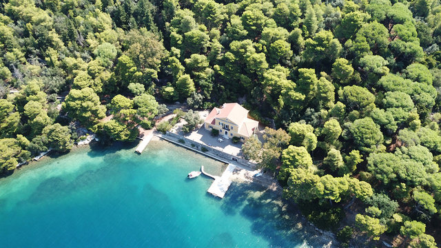 Aerial drone photo of iconic uninhabited island of Madouri in bay of Nydri and Mansion of 19th-century poet Aristotelis Valaoritis, Lefkada, Ionian, Greece