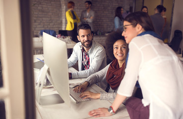 Female manager looking working task on computer in office