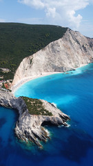 Obraz premium Aerial drone photo of popular tropical paradise deep turquoise beach of Porto Katsiki with white steep rocky seascape and beautiful cloudy landscape, Lefkada island, Ionian, Greece