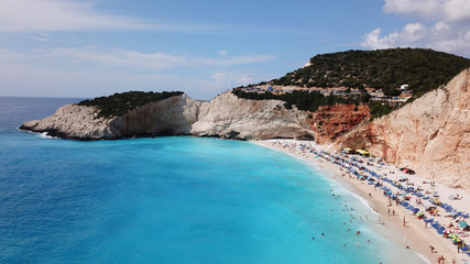 Fototapeta premium Aerial drone photo of popular tropical paradise deep turquoise beach of Porto Katsiki with white steep rocky seascape and beautiful cloudy landscape, Lefkada island, Ionian, Greece