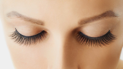 Female eye with extreme long false eyelashes. Eyelash extensions, make-up, cosmetics, beauty and skin care