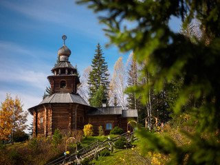   wooden chapel temple with a poppy and a cross in a circle on a hill          