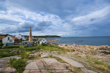 Fototapeta na wymiar View of small town on beautiful stony coast of Bornholm island - Sandvig, Denmark