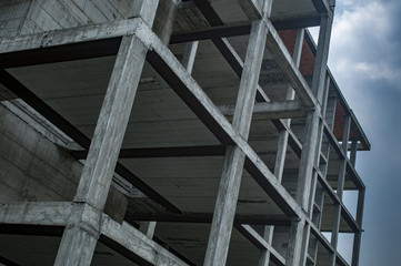 construction site, reinforced concrete structure on cloudy sky background
