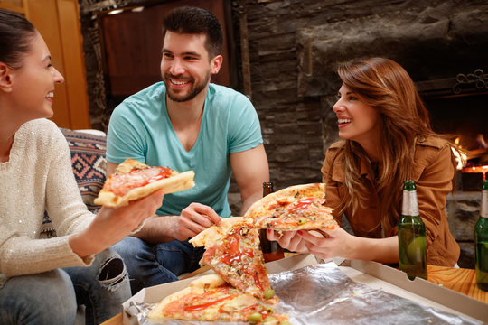 Friends together enjoying in tasty of big pizza