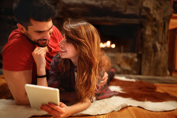 Love couple together looking on tablet