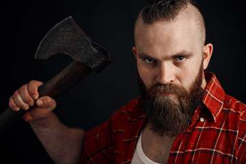 Dangerous brutal Aggressive bearded man with axe. man run into camera