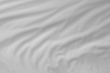 Obraz premium folded orange material texture with blurred focus - abstract photo background for use as background.