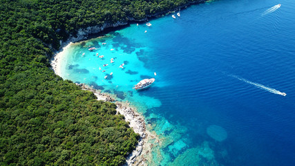 Fototapeta na wymiar Aerial drone bird's eye view photo of iconic paradise sandy beach of blue lagoon with deep turquoise clear sea and pine trees in complex island of Mourtos in Sivota area, Epirus, Greece