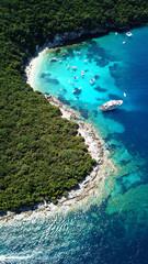 Aerial drone bird's eye view photo of iconic paradise sandy beach of blue lagoon with deep turquoise clear sea and pine trees  in complex island of Mourtos in Sivota area, Epirus, Greece - obrazy, fototapety, plakaty