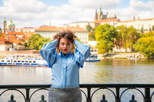 Portrait of young woman Old Town of Prague and river Vltava background in sunny september day, Czech Republic