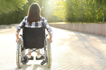 Young woman in wheelchair outdoors