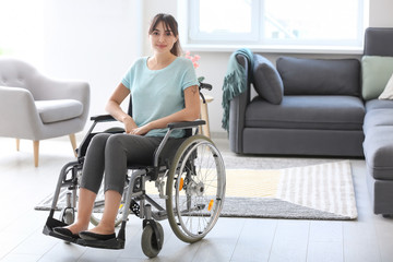 Young woman in wheelchair at home
