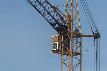 Cab of a construction crane against a blue sky