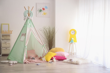 Cozy play tent for kids in interior of room