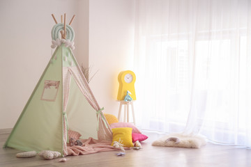 Cozy play tent for kids in interior of room