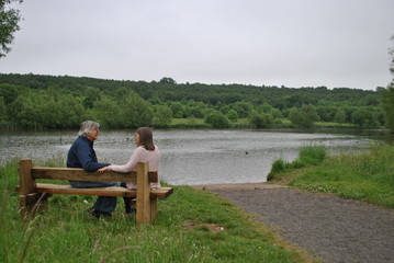 Man and Woman sitting on park bench