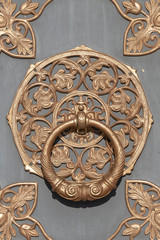 Door knocker on ancient wooden door in Kiev, Ukraine