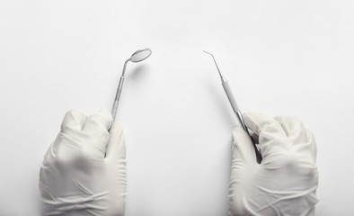 Dentist with tools on white background