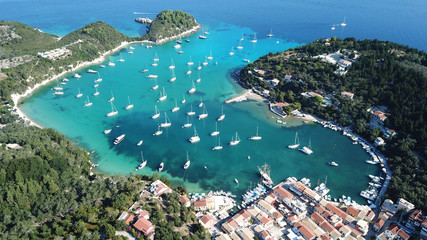 Aerial drone bird's eye view photo of iconic small port and fishing village of Lakka with traditional Ionian architecture and sail boats docked, Paxos island, Ionian, Greece - obrazy, fototapety, plakaty
