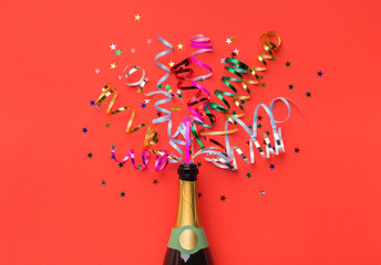 Champagne bottle with colorful streamers top view