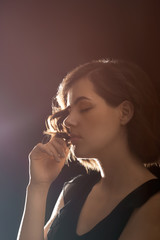 Portrait of beautiful young woman on dark background