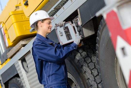worker checking the vehicle