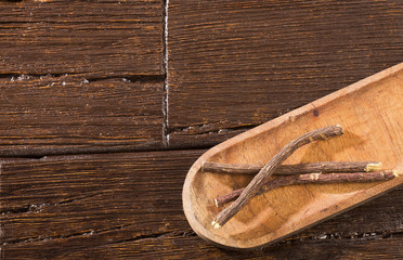 Licorice stems - Glycyrrhiza glabra. Wooden background
